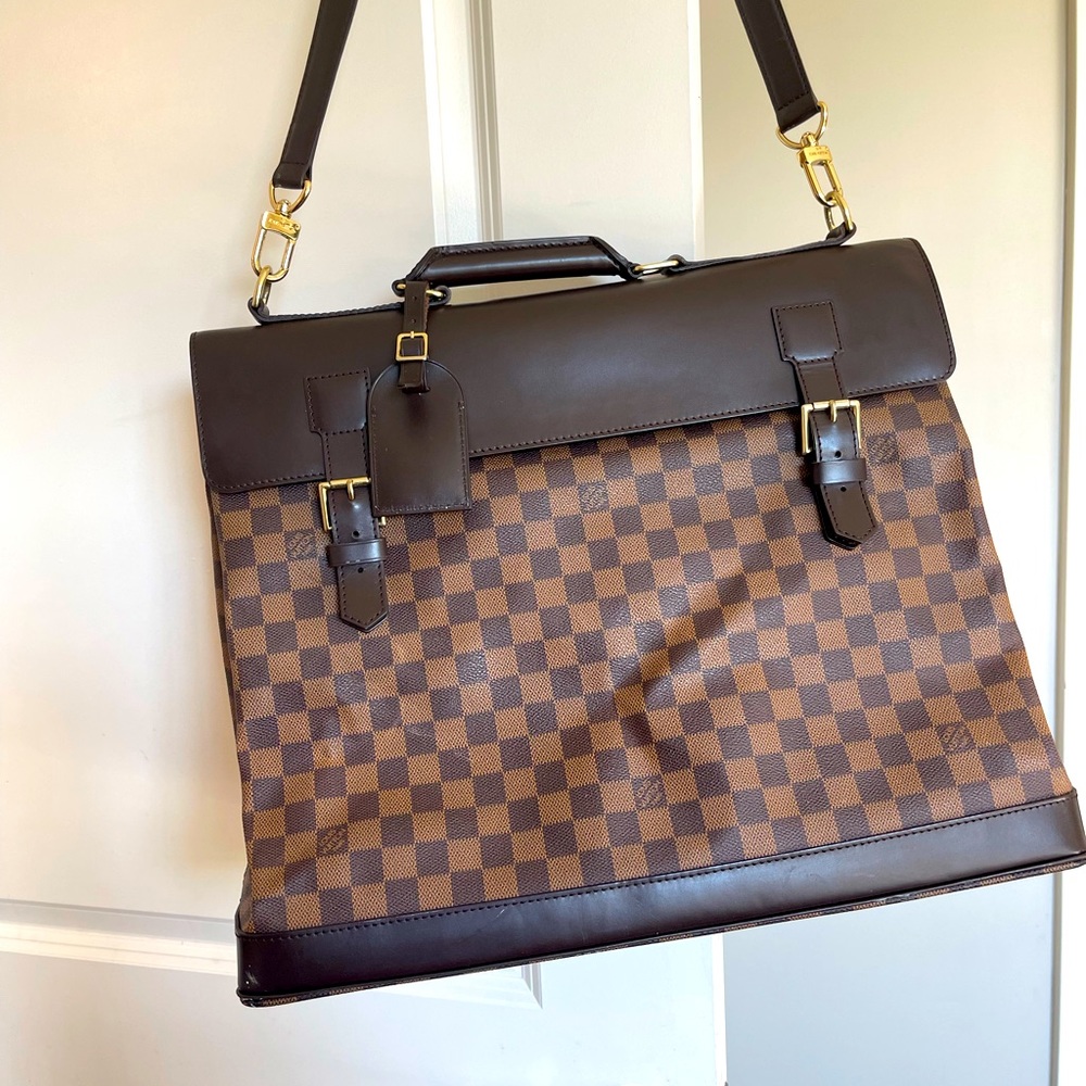Louis Vuitton Travel Bag with strap.